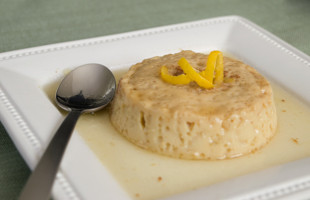 Flan on a plate with a spoon