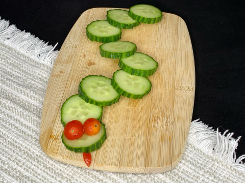 Vegetable Snake on a wooden cutting board